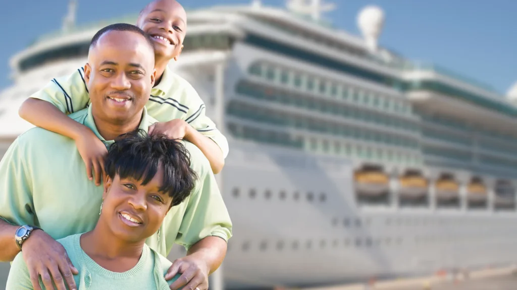 a husband, wife, and child in front of a cruise ship about to board the ship