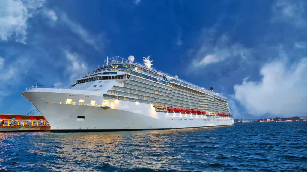 a cruise ship on the water during sunset time