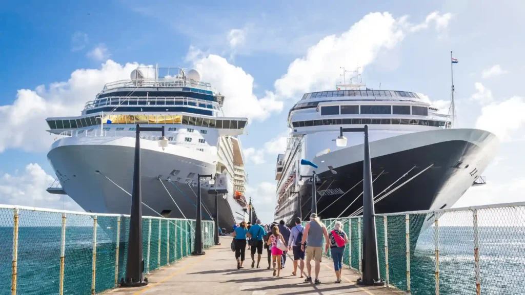 people walking to a dock where they will board on a cruise ship headed to their safe cruise destination