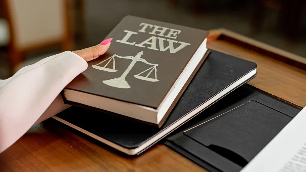 a maritime lawyer holding a book of maritime law on cruise ships