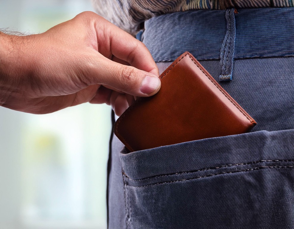 Someone stealing a wallet out of a man's back pocket